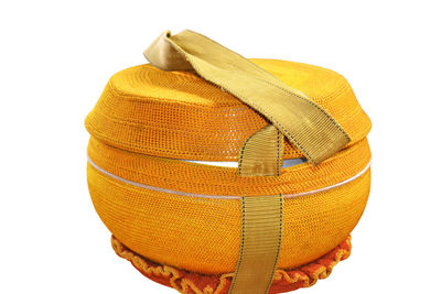 Close-up of yellow hat against white background