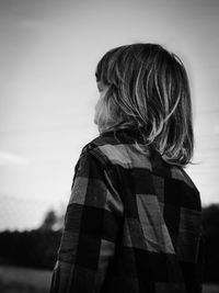 Rear view of woman standing against sky