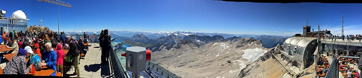 Scenic view of mountains against blue sky