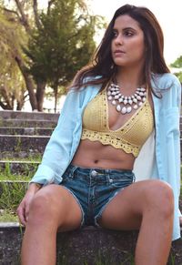 Portrait of beautiful young woman sitting outdoors