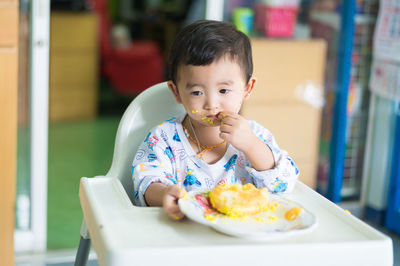 Portrait of cute girl eating food