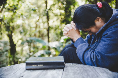 Woman hands praying to god with the bible. begging for forgiveness and believe in goodness.