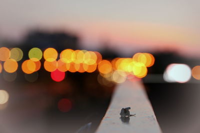 Defocused image of illuminated christmas lights in city at night