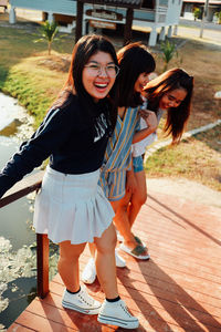 Full length of smiling young woman