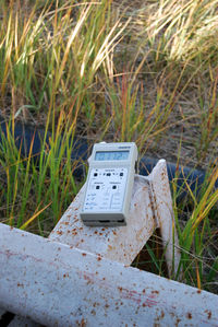 Close-up of telephone booth on field