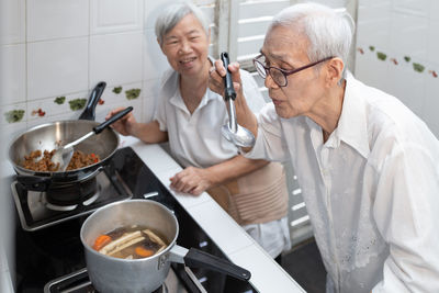 People having food in kitchen