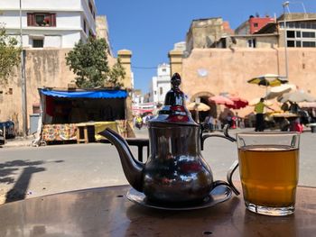 Glasses on table against buildings in city