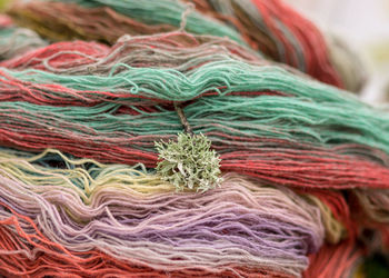 Colored wool yarn skeins on a fuzzy background, handicraft concept, hand knitting