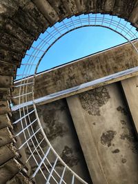 Low angle view of staircase by building against sky