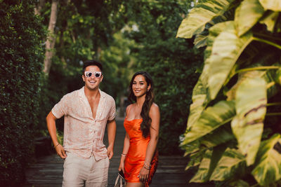 Fashion shot of an attractive young couple in summer clothes posing outdoor