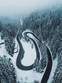 High angle view of winding road amidst snow covered landscape