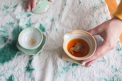 High angle view of woman holding tea cup