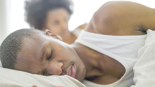 Close-up of couple kissing on bed