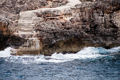 Scenic view of sea by rock formation