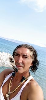 Portrait of mature woman on beach against sky