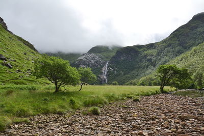 Scenic view of landscape and mountains against sky