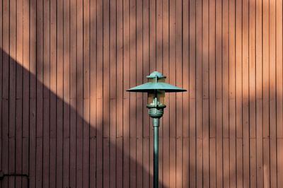 Close-up of electric lamp on wall