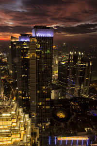 High angle view of illuminated buildings in city at night