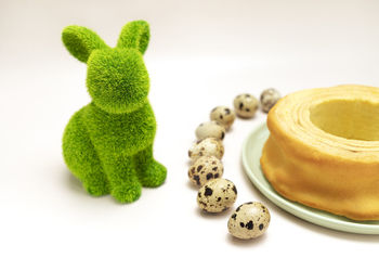 Easter concept. green hare, rabbit with quail eggs and delicious baumkuchen, sakotis ,sekacz pie on