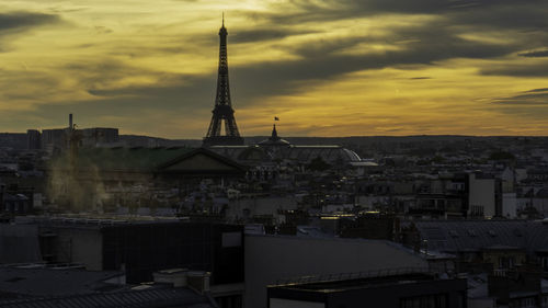 View of buildings against cloudy sky at sunset