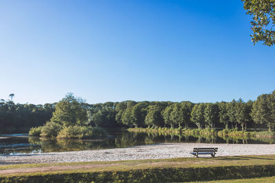 Scenic view of lake against clear blue sky