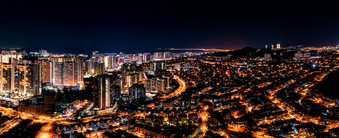 High angle view of illuminated city buildings at night