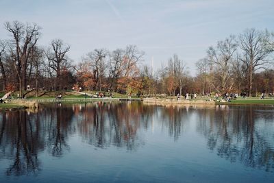 Reflection of trees in lake against sky in park