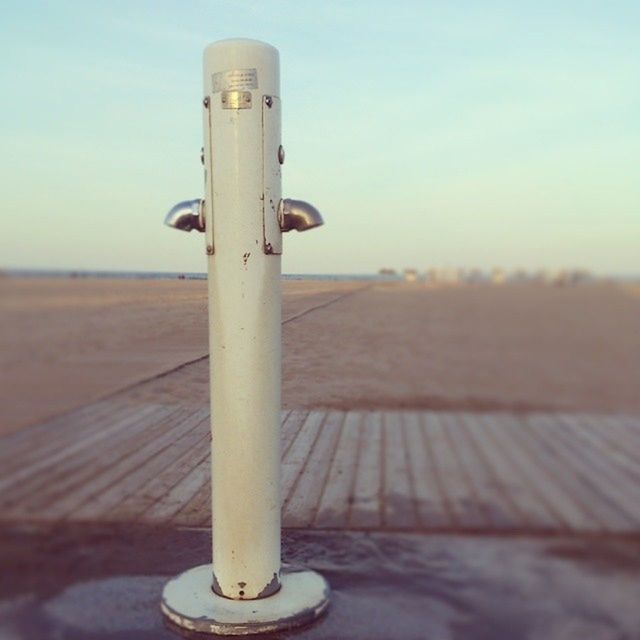 metal, focus on foreground, sky, close-up, metallic, rusty, no people, beach, wood - material, outdoors, safety, day, protection, pole, security, sand, clear sky, sunlight, selective focus, sea