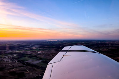 Aerial view of city against sky during sunset