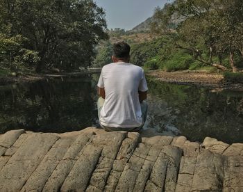 Rear view of man sitting outdoors