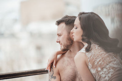 Side view of couple kissing outdoors