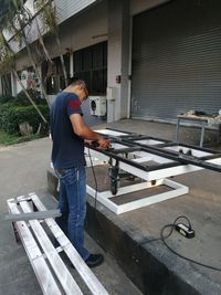 Side view of man working on floor