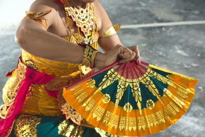 Midsection of woman holding umbrella