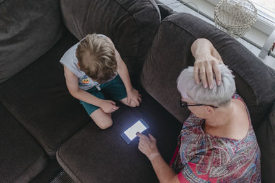 Grandmother with grandson using cell phone