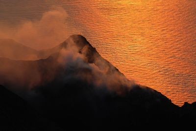 Scenic view of sea against orange sky