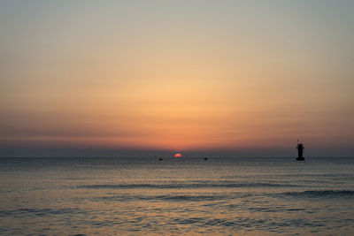 Scenic view of sea against sky at sunset