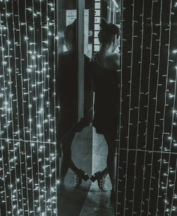 Woman standing in illuminated room