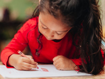 Cute girl drawing at home
