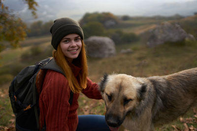 Portrait of smiling young woman with dog