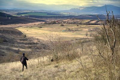 Man on field against mountain range