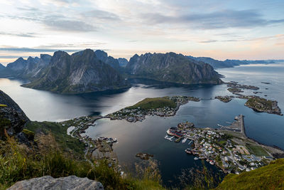 Scenic view of sea and mountains against sky