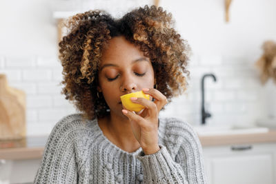 Portrait of young woman holding toy