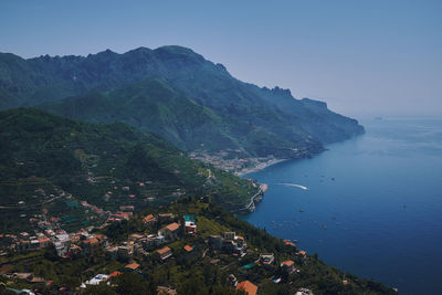 High angle view of townscape by sea against sky