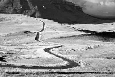 Scenic view of road by mountains