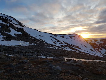 Scenic view of snowcapped mountains against sky during sunset