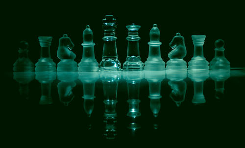 Close-up of chess pieces against black background