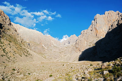 Scenic view of rocky mountains against blue sky