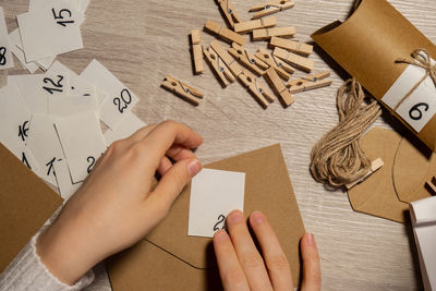 Cropped hands of woman drawing on table