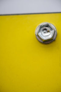 Close-up of yellow metal on table