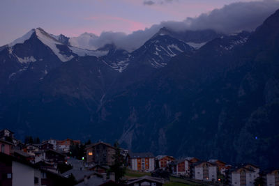 Town by mountains against sky